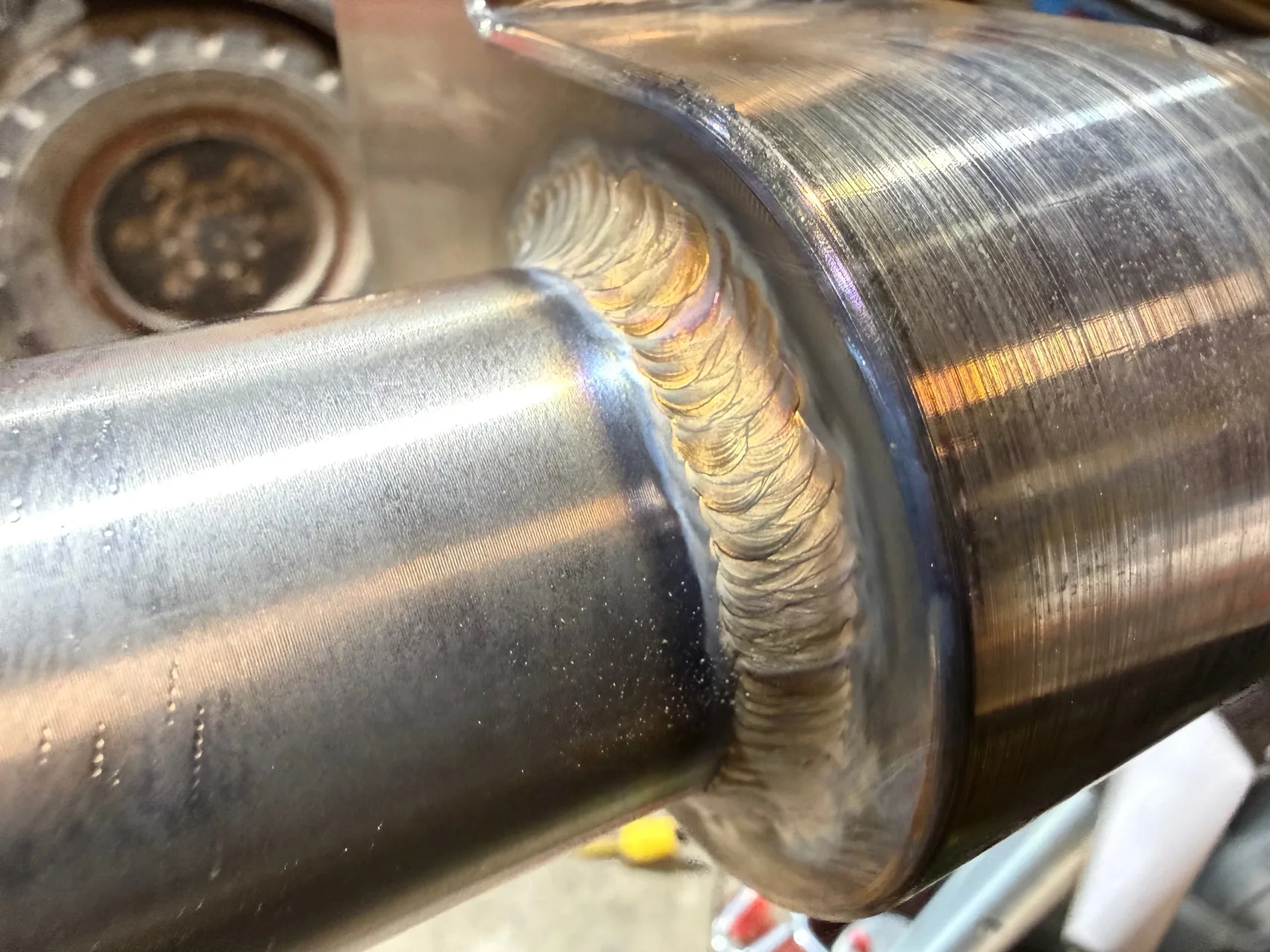 Close-up of a precision multi-pass TIG weld on polished stainless food-grade shafts by Sons of Thunder Welding