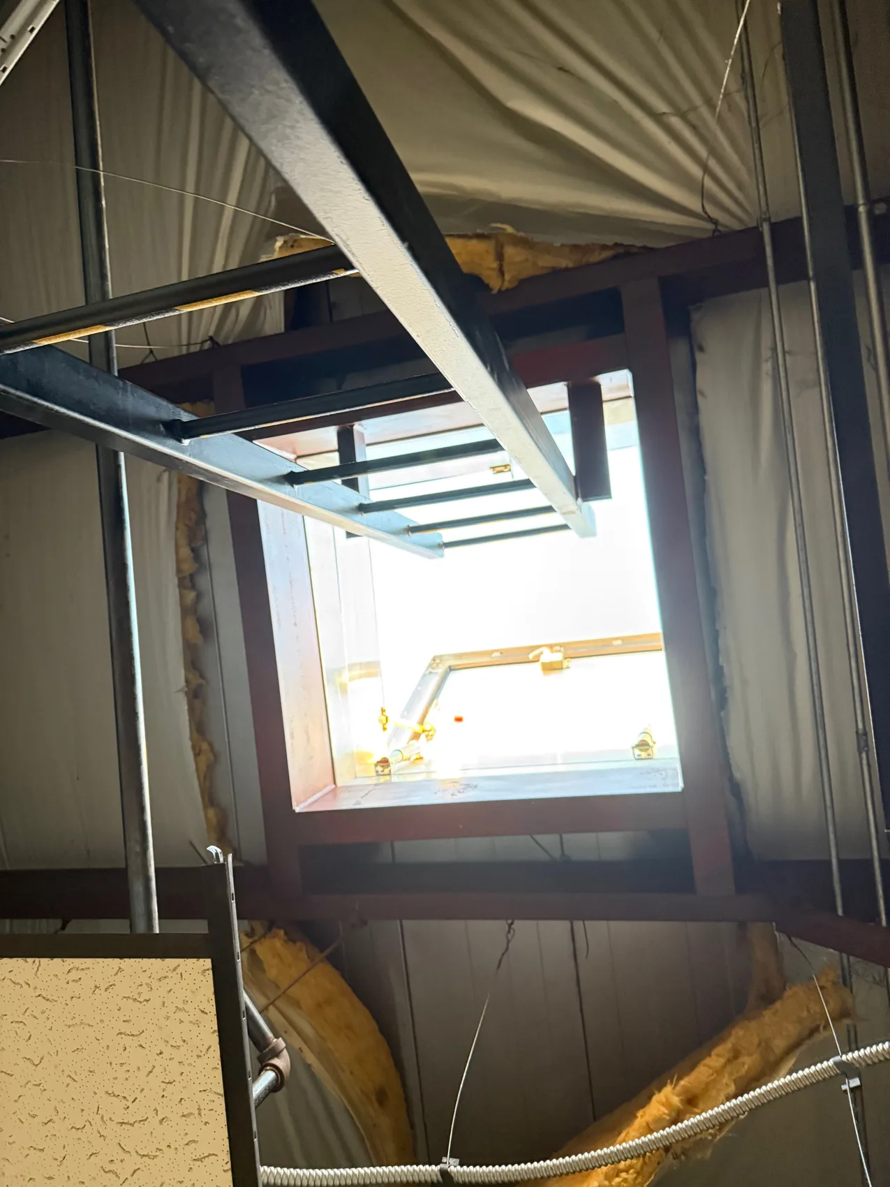 Roof access hatch with welded structural steel framing and a steel ship's ladder by Sons of Thunder Welding